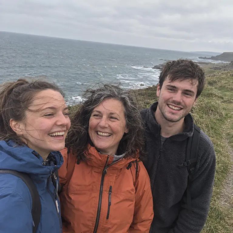 Helen and her grown-up children on a windy coastal walk