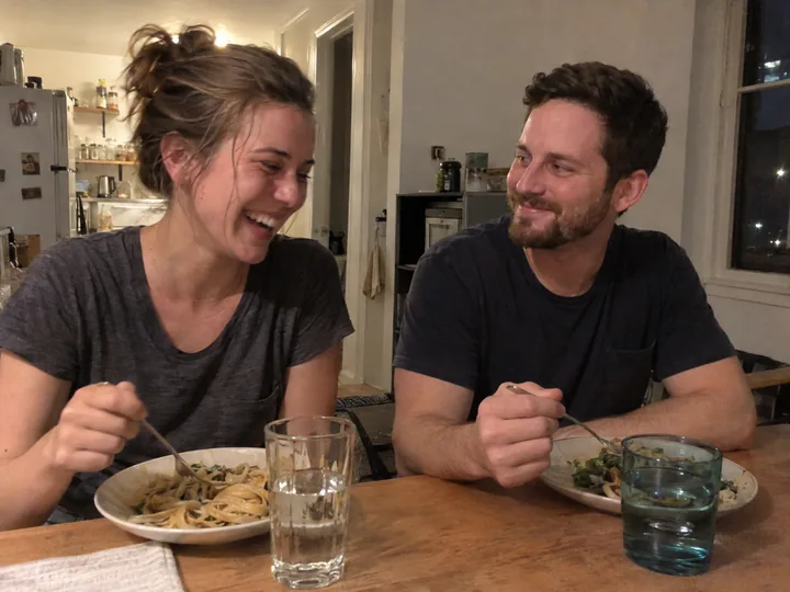 A married couple sharing dinner at their kitchen table