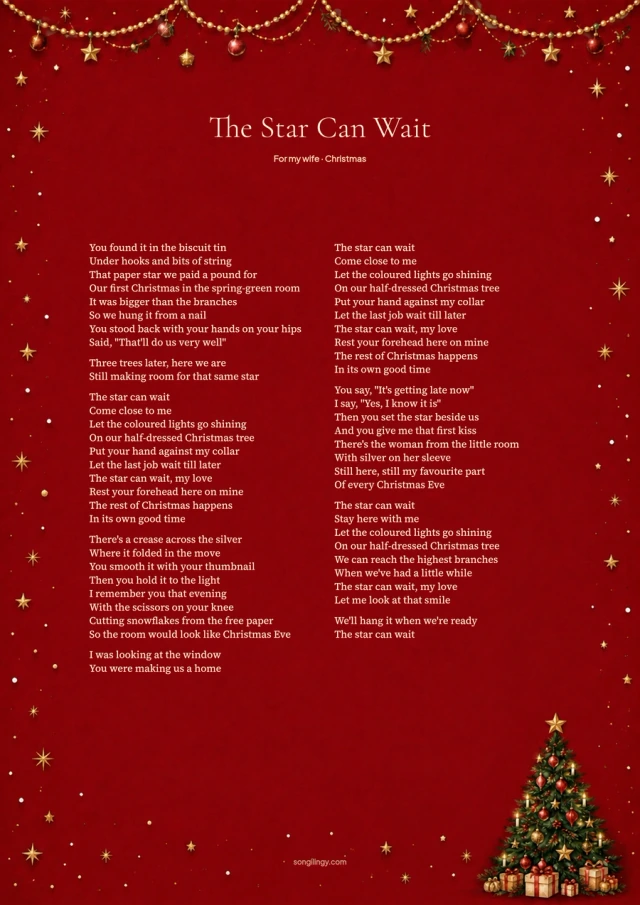 Christmas song lyrics beside a decorated tree on cranberry red